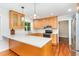 Well-lit kitchen with custom cabinets, white countertops and modern appliances at 106 Wolfs Trl, Chapel Hill, NC 27516