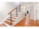 Modern staircase featuring wood treads and minimalist railing design at 106 Wolfs Trl, Chapel Hill, NC 27516