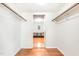 Spacious walk-in closet with hardwood floors and wood trim at 106 Wolfs Trl, Chapel Hill, NC 27516