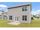 Exterior of home showing backyard with well-maintained lawn, a patio, and double glass doors at 108 White Burley Ct, Durham, NC 27703