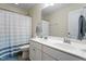 Bright bathroom featuring a double sink vanity with ample countertop space and modern fixtures and striped shower curtain at 108 White Burley Ct, Durham, NC 27703