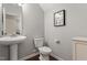 Powder room features pedestal sink, toilet, and neutral wall color at 108 White Burley Ct, Durham, NC 27703