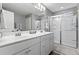 Bathroom features double sink vanity, shower with glass door, and neutral wall color at 108 White Burley Ct, Durham, NC 27703
