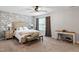 Bedroom with floral wallpaper accent wall, ceiling fan, and carpeted floors at 108 White Burley Ct, Durham, NC 27703