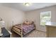 Cozy bedroom with neutral carpet and a charming bed frame and natural light from the exterior window at 108 White Burley Ct, Durham, NC 27703