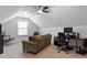 Comfortable bonus room with a ceiling fan, a cozy sofa, a large window, and a well lit desk for work at 108 White Burley Ct, Durham, NC 27703