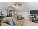 Inviting bonus room with a comfortable couch, TV, desk, and stylish bookshelves at 108 White Burley Ct, Durham, NC 27703