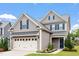 Charming two-story home with gray siding, blue shutters, manicured lawn, and an attached two-car garage at 108 White Burley Ct, Durham, NC 27703
