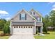 Charming two-story home with gray siding, blue shutters, two-car garage and lovely landscaping at 108 White Burley Ct, Durham, NC 27703