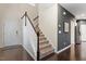 Foyer with hardwood floors, carpeted stairs, and access to kitchen and front door at 108 White Burley Ct, Durham, NC 27703