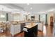 Bright kitchen featuring white cabinetry, stainless steel appliances, and a center island at 108 White Burley Ct, Durham, NC 27703