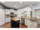 Well-lit kitchen showcasing white cabinets, granite countertops, and stainless steel appliances at 108 White Burley Ct, Durham, NC 27703