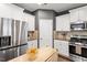Kitchen featuring stainless steel refrigerator, oven, white cabinets, and wooden countertops at 108 White Burley Ct, Durham, NC 27703