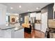 Modern kitchen with stainless steel appliances, granite countertops, and a breakfast bar at 108 White Burley Ct, Durham, NC 27703