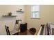Home office space featuring two floating shelves, music stand, hardwood floors and a sleek, modern design at 108 White Burley Ct, Durham, NC 27703