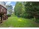 Expansive backyard with lush lawn, surrounded by trees, providing privacy and space for outdoor activities at 110 Benedum Pl, Cary, NC 27518