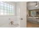 Relaxing tub featuring subway tile surround, decorative bath caddy and Primary bedroom view at 110 Benedum Pl, Cary, NC 27518