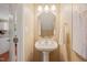 Powder room features pedestal sink, vanity mirror, modern lighting and neutral wall color at 110 Benedum Pl, Cary, NC 27518