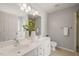 Bright bathroom featuring a double sink vanity, large mirror, and neutral color palette at 110 Benedum Pl, Cary, NC 27518
