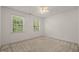 Bedroom with windows providing natural light, complemented by neutral tones at 110 Benedum Pl, Cary, NC 27518