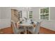 Bright dining room with hardwood floors, a modern chandelier, and a stylish round table set for four at 110 Benedum Pl, Cary, NC 27518