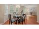 Stylish dining area with a glass-topped table and views into the living room at 110 Benedum Pl, Cary, NC 27518