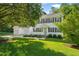 Beautiful white two-story home with an attached two-car garage and lush green lawn at 110 Benedum Pl, Cary, NC 27518