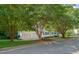Charming home exterior, showcases a well-manicured lawn, mature trees, and a two-car garage, enhancing curb appeal at 110 Benedum Pl, Cary, NC 27518