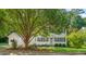 Charming white two-story home with black shutters and a well-manicured front yard landscape at 110 Benedum Pl, Cary, NC 27518