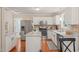 Modern kitchen features granite countertops, stainless steel appliances, island and hardwood floors at 110 Benedum Pl, Cary, NC 27518