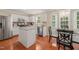 Bright kitchen features white cabinets, stainless steel appliances, granite countertops and eat-in breakfast nook at 110 Benedum Pl, Cary, NC 27518