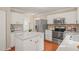 Open kitchen features white cabinets, granite countertops, stainless steel appliances and kitchen island at 110 Benedum Pl, Cary, NC 27518