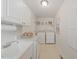 Bright laundry room equipped with modern washer and dryer and plenty of counter space at 110 Benedum Pl, Cary, NC 27518