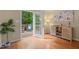 Inviting sunroom with hardwood floors, a cabinet and a view of the outdoor deck at 110 Benedum Pl, Cary, NC 27518