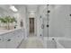 Modern bathroom featuring double vanities, a glass-enclosed shower, and a soaking tub at 1100 Balsawood Dr # 5, Durham, NC 27705