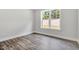 Bedroom featuring dark wood flooring, and a large window providing ample natural light and scenic views at 1100 Balsawood Dr # 5, Durham, NC 27705
