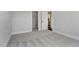 This bedroom features neutral walls, plush carpeting, and a walk-in closet adjacent to an ensuite bathroom at 1100 Balsawood Dr # 5, Durham, NC 27705