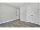 Spacious bedroom showcasing dark wood floors and white closets and doors enhancing the aesthetic at 1100 Balsawood Dr # 5, Durham, NC 27705