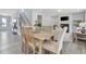 Open dining room features a wood table with seating and staircase views, creating an inviting space at 1100 Balsawood Dr # 5, Durham, NC 27705