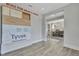 View of dining room with shiplap accent wall, light fixture, and windows from open-concept space at 1100 Balsawood Dr # 5, Durham, NC 27705