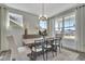 Well-lit dining room with large windows and stylish furniture creates a welcoming dining experience at 1100 Balsawood Dr # 5, Durham, NC 27705