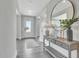 Inviting entryway with wood floors, console table, mirror, and decor creating a great first impression at 1100 Balsawood Dr # 5, Durham, NC 27705