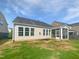 Exterior view of home with a screened porch and partially seeded lawn at 120 Martingale Dr, Holly Springs, NC 27540