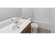 Well-lit bathroom with a vanity, mirror, toilet, and a bathtub with shower at 120 Martingale Dr, Holly Springs, NC 27540