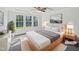 Bright bedroom with large windows, ceiling fan, and a well-appointed bed at 120 Martingale Dr, Holly Springs, NC 27540