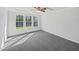 A room with gray carpet, white walls, and a bright window at 120 Martingale Dr, Holly Springs, NC 27540