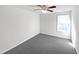 Well-lit bedroom featuring carpet floors, a ceiling fan, and a window at 120 Martingale Dr, Holly Springs, NC 27540