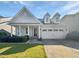 Charming single-Gathering home with a well-manicured lawn, a two car garage, and a welcoming front porch at 120 Martingale Dr, Holly Springs, NC 27540