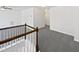 A long hallway with gray floors and white walls at 120 Martingale Dr, Holly Springs, NC 27540