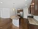 Spacious kitchen featuring a large island, modern appliances, and dark wood cabinets at 120 Martingale Dr, Holly Springs, NC 27540